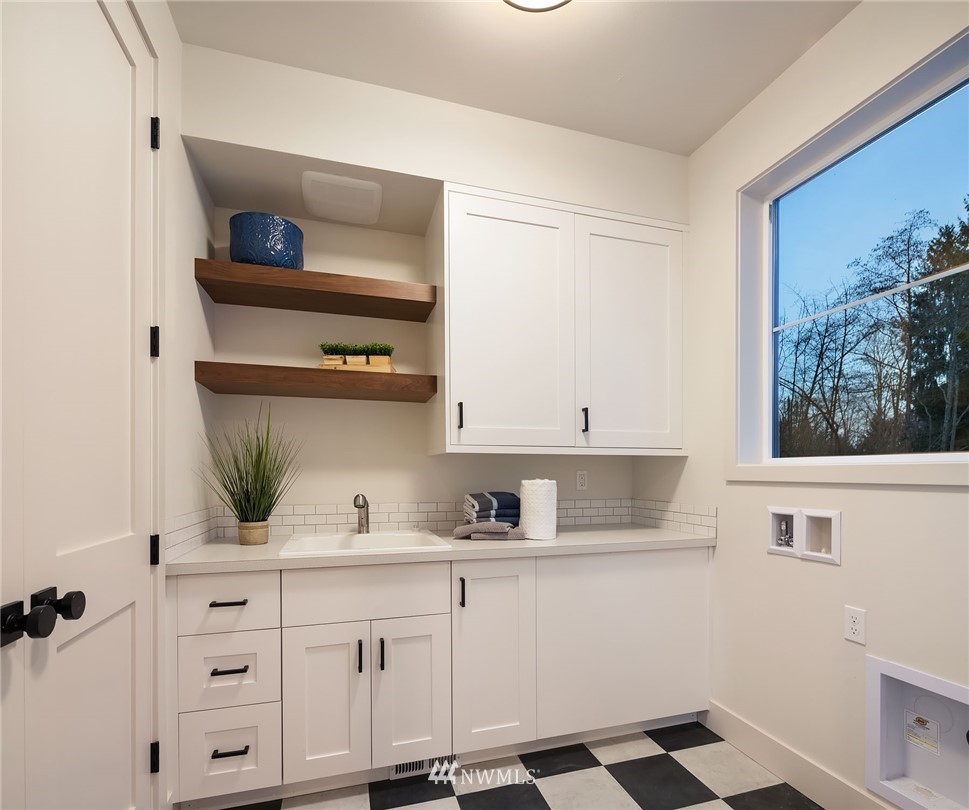 23517 7th Avenue Southeast Bothell, WA 98021 - Photo 27 of 32 a kitchen with white cabinets and appliances