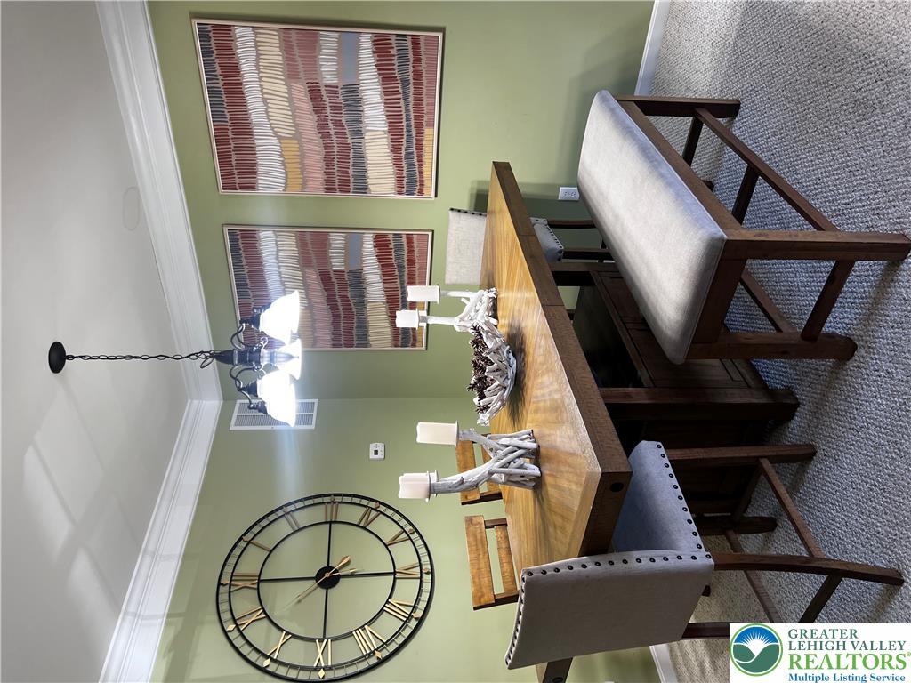 8549 Gateway Road Breinigsville, PA 18031 - Photo 8 of 26 Formal dining space features elegant crown molding and a classic chandelier.