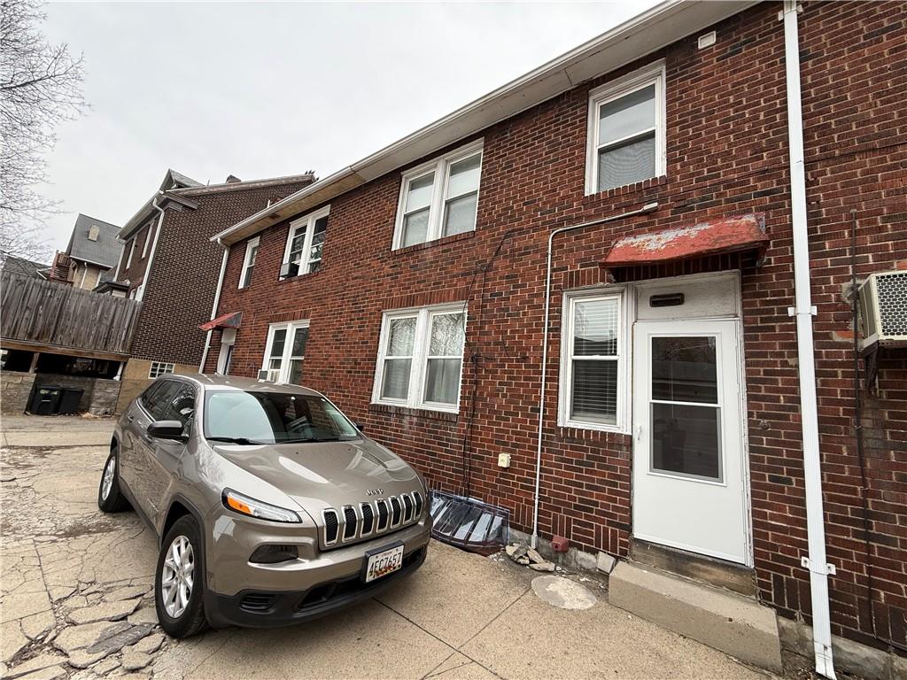 2332 Sherbrook Street Pittsburgh, PA 15217 - Photo 2 of 40 a car parked in front of a brick house