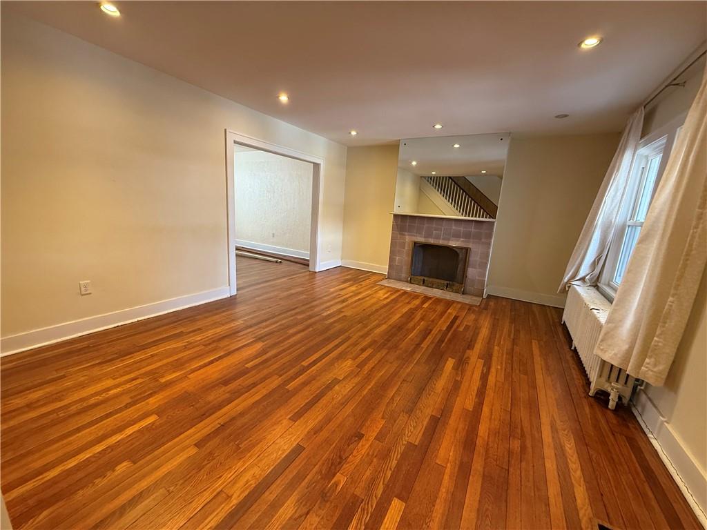 2332 Sherbrook Street Pittsburgh, PA 15217 - Photo 24 of 40 wooden floor in an empty room with a fireplace