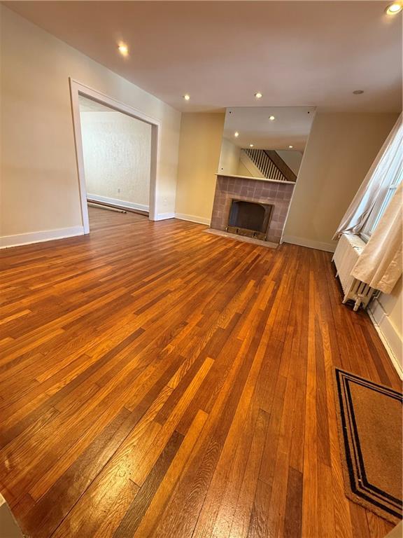 2332 Sherbrook Street Pittsburgh, PA 15217 - Photo 25 of 40 a view of an empty room with wooden floor and a kitchen