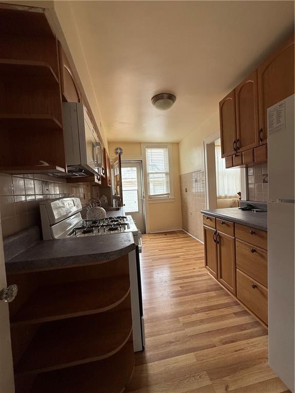 2332 Sherbrook Street Pittsburgh, PA 15217 - Photo 34 of 40 a kitchen with stainless steel appliances granite countertop a stove and a refrigerator