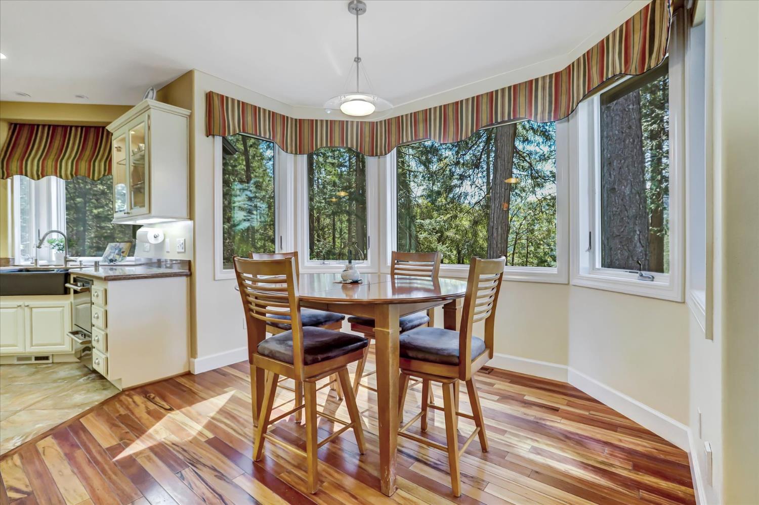 10973 Scotts Flat Dam Road Nevada City, CA 95959 - Photo 14 of 91 a view of a dining room with furniture window and wooden floor