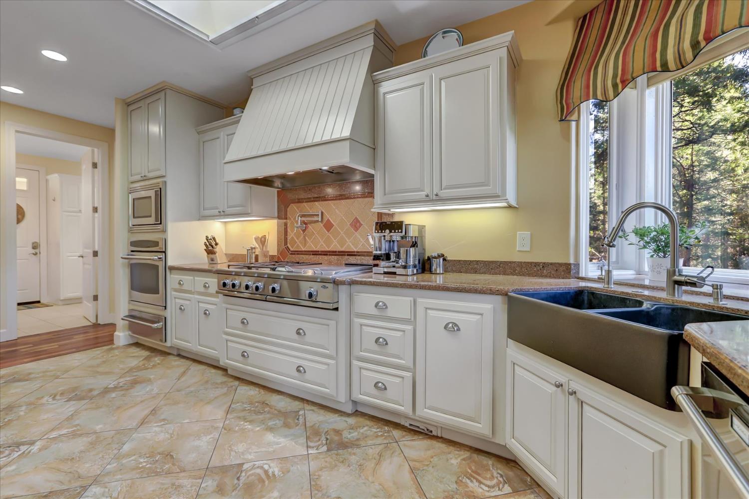 10973 Scotts Flat Dam Road Nevada City, CA 95959 - Photo 20 of 91 a kitchen with granite countertop a sink stainless steel appliances and cabinets