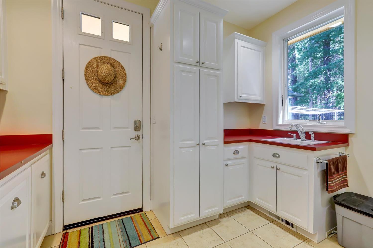 10973 Scotts Flat Dam Road Nevada City, CA 95959 - Photo 27 of 91 a view of a kitchen with cabinets dryer and washer