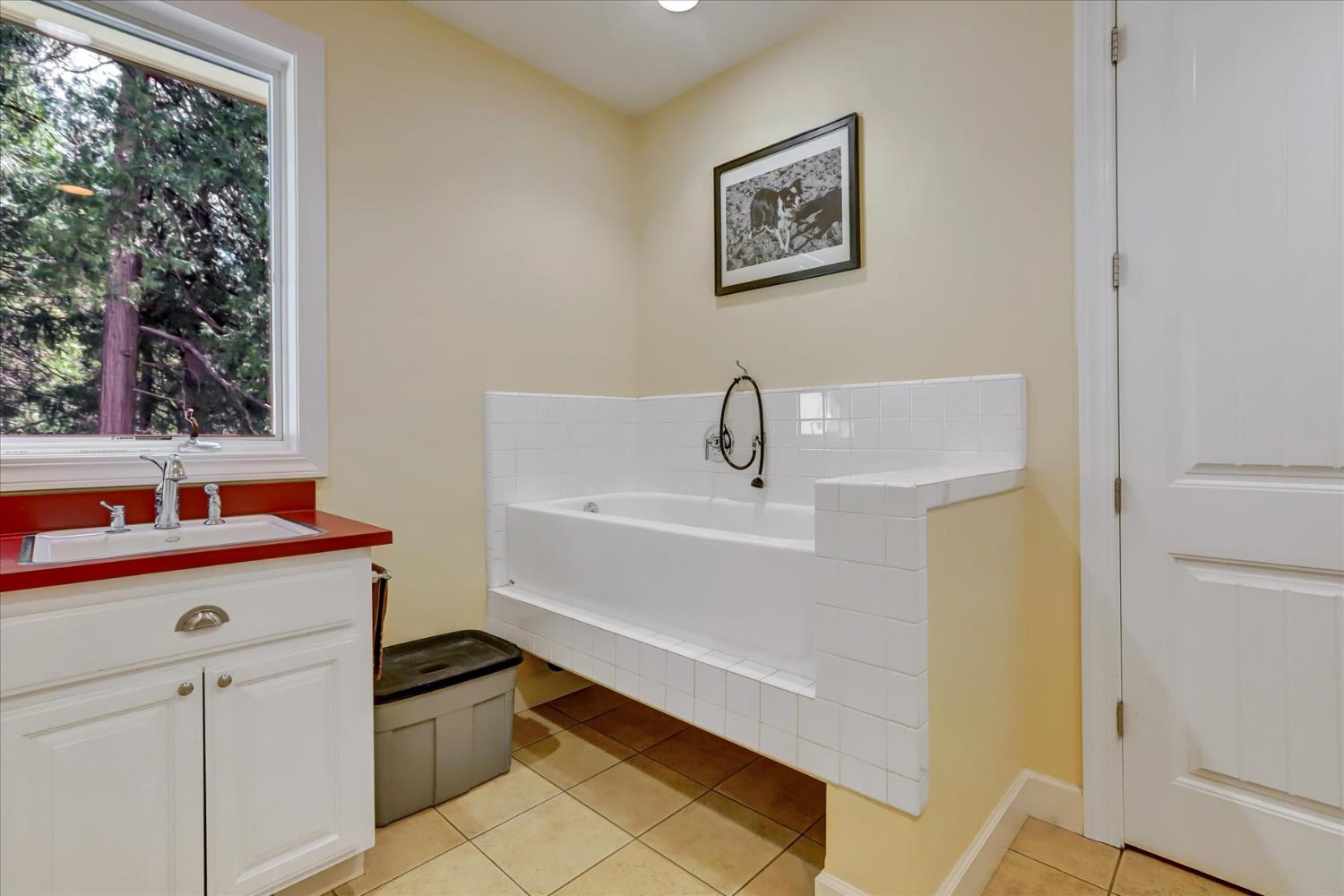 10973 Scotts Flat Dam Road Nevada City, CA 95959 - Photo 28 of 91 a bathroom with a sink and a bathtub