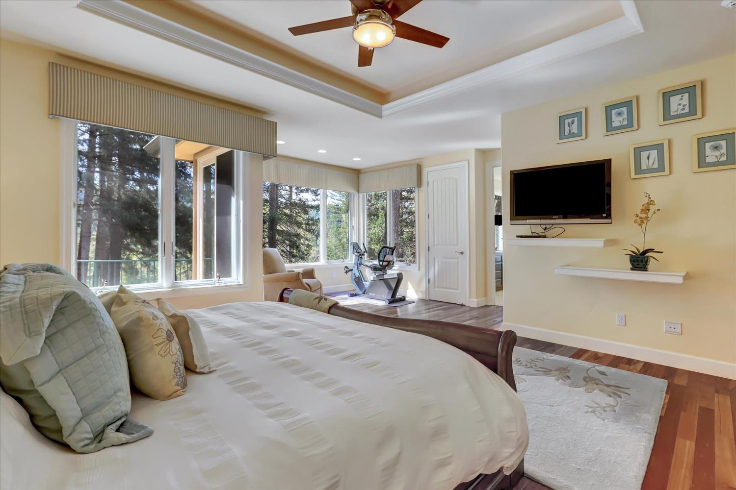10973 Scotts Flat Dam Road Nevada City, CA 95959 - Photo 33 of 91 a spacious bedroom with a bed and flat screen tv