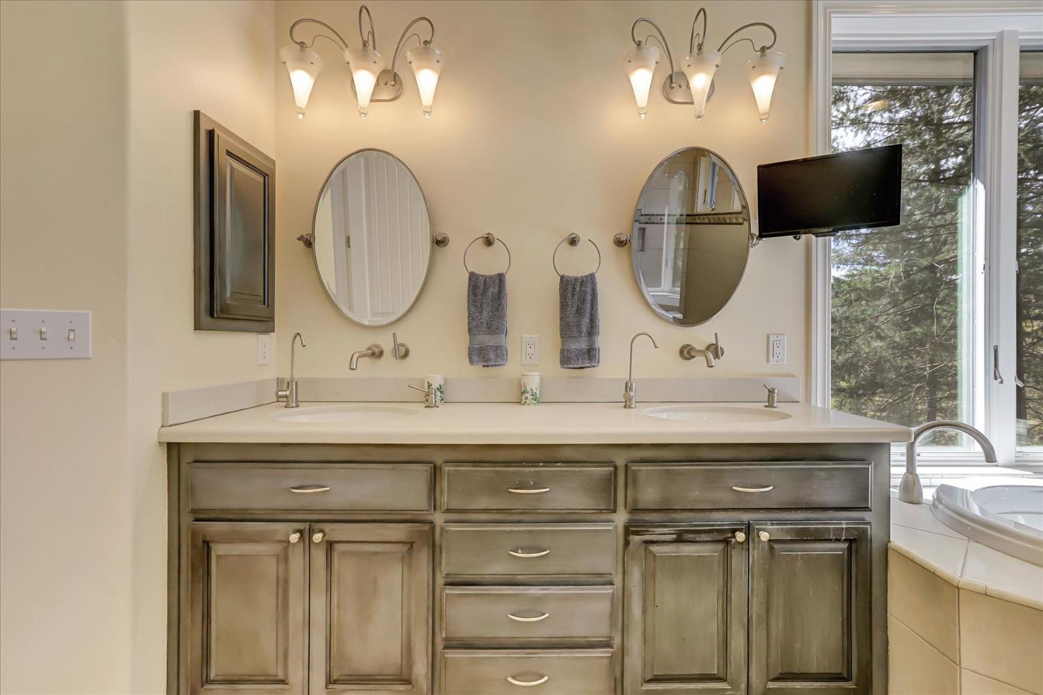 10973 Scotts Flat Dam Road Nevada City, CA 95959 - Photo 38 of 91 a bathroom with a double vanity sink and a mirror