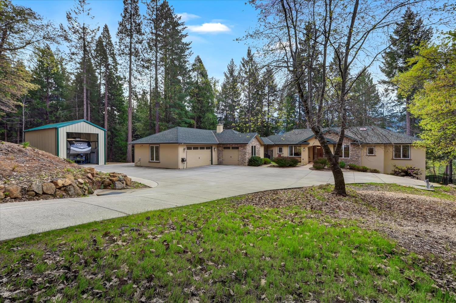 10973 Scotts Flat Dam Road Nevada City, CA 95959 - Photo 4 of 91 a front view of a house with a garden and trees