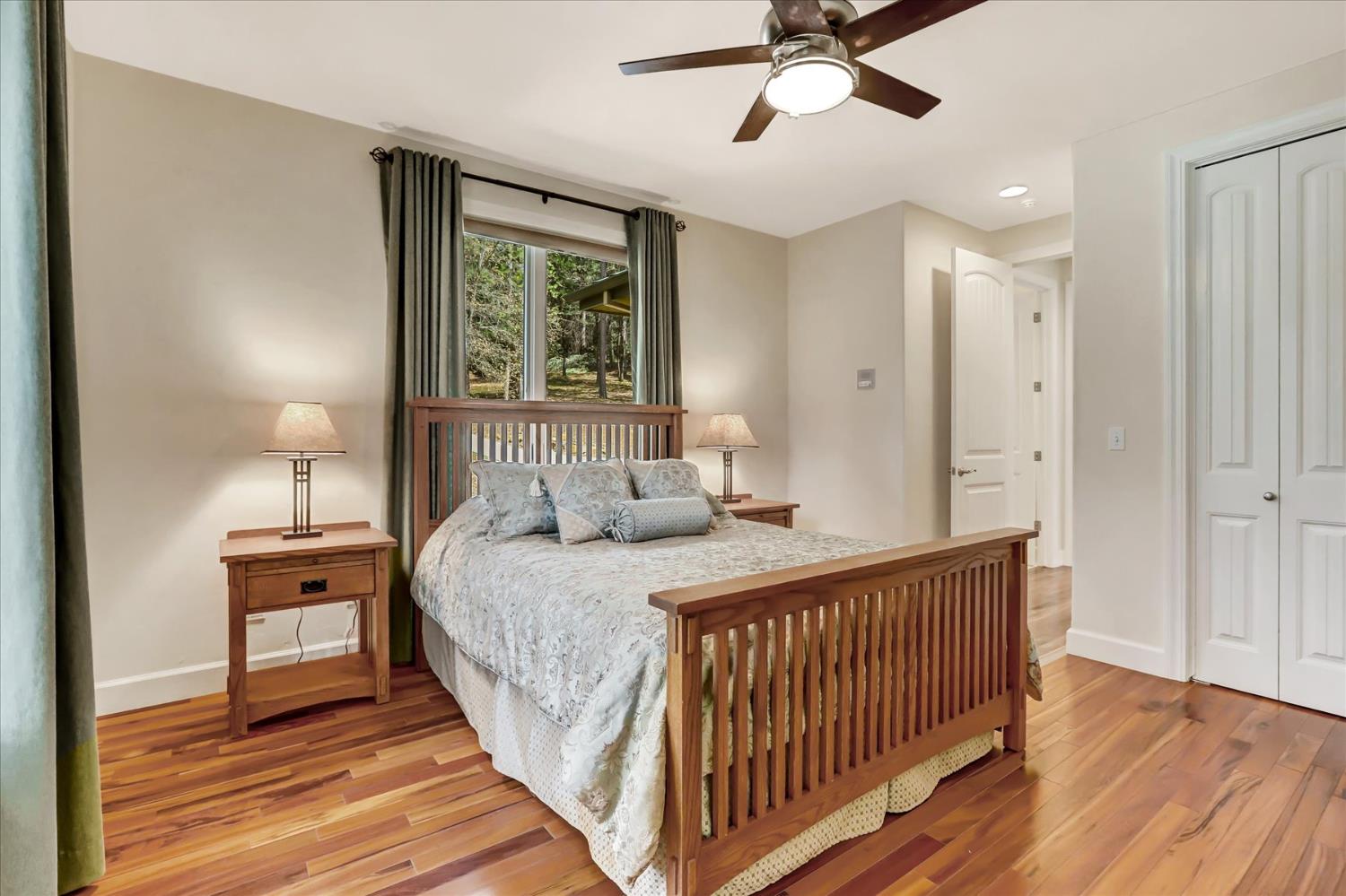 10973 Scotts Flat Dam Road Nevada City, CA 95959 - Photo 48 of 91 a bedroom with a bed and a chandelier
