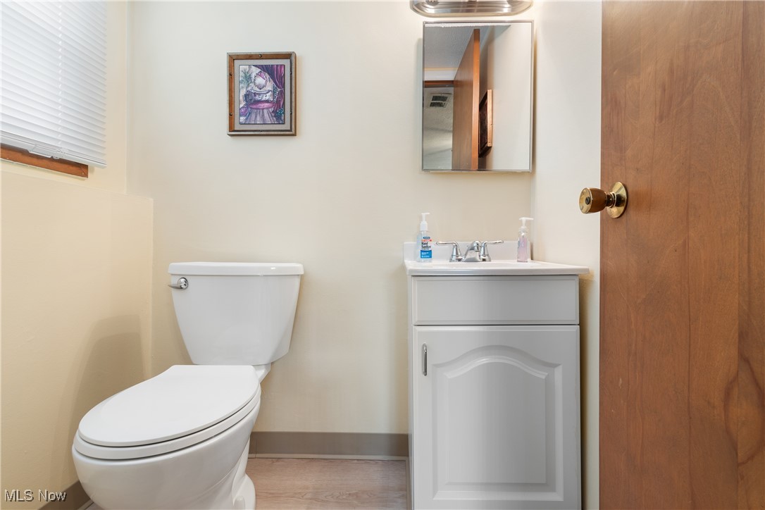 447 Center Road Bedford, OH 44146 - Photo 26 of 33 Bathroom with toilet, baseboards, and vanity