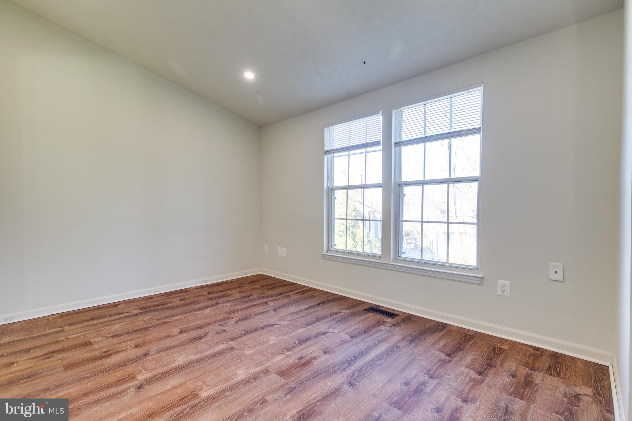 1589 Woodcrest Drive Reston, VA 20194 - Photo 19 of 29 an empty room with wooden floor and windows