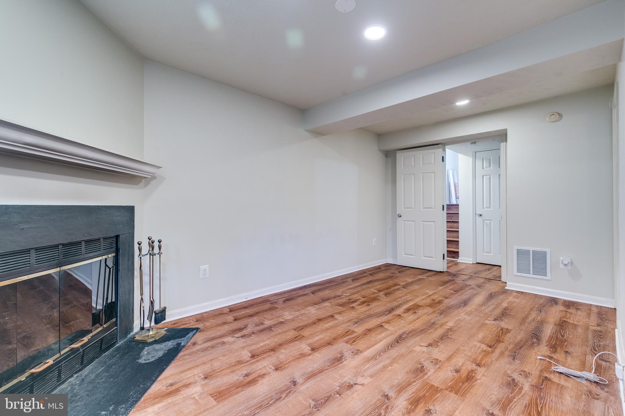 1589 Woodcrest Drive Reston, VA 20194 - Photo 26 of 29 a view of empty room with wooden floor and fireplace