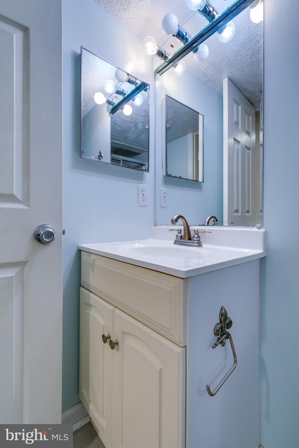 1589 Woodcrest Drive Reston, VA 20194 - Photo 28 of 29 a bathroom with a sink vanity and mirror