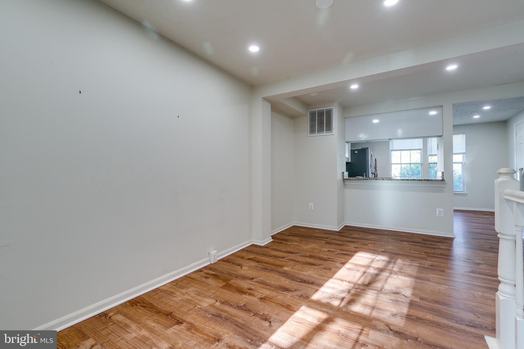 1589 Woodcrest Drive Reston, VA 20194 - Photo 8 of 29 a view of kitchen with kitchen island a sink dishwasher and a refrigerator with wooden floor