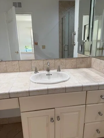 a bathroom with a sink and a mirror