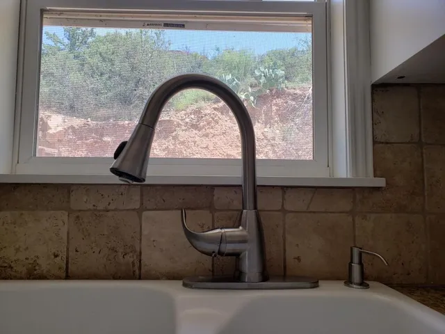 a view of a balcony with wooden floor and a bench