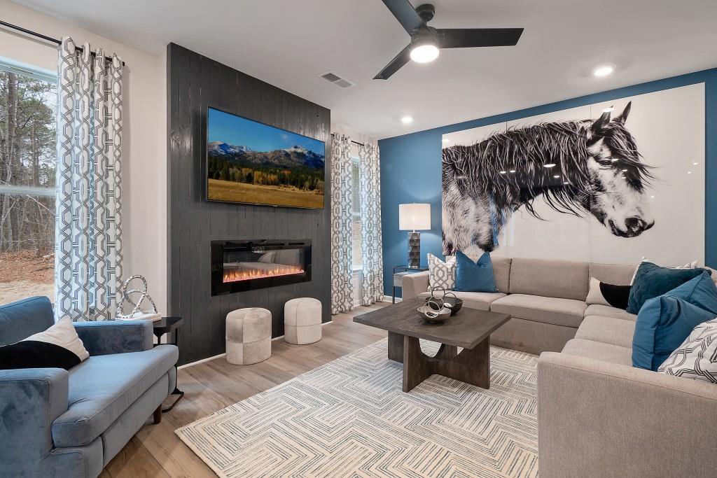 57 Scout Way Newnan, GA 30263 - Photo 19 of 37 a living room with furniture a lamp and a ceiling fan