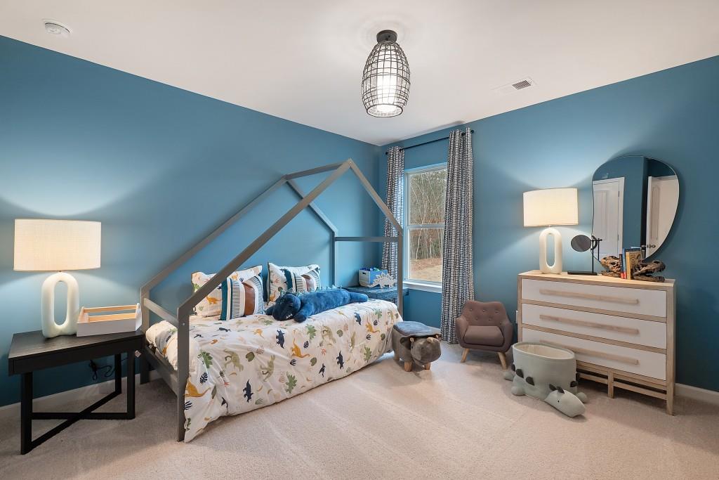 57 Scout Way Newnan, GA 30263 - Photo 28 of 37 a bedroom with bed and a chandelier