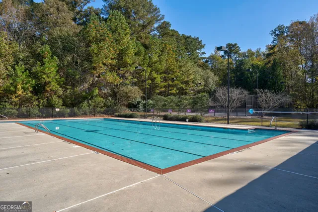 a view of a swimming pool with a yard
