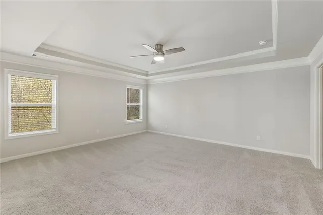 an empty room with a window and a ceiling fan