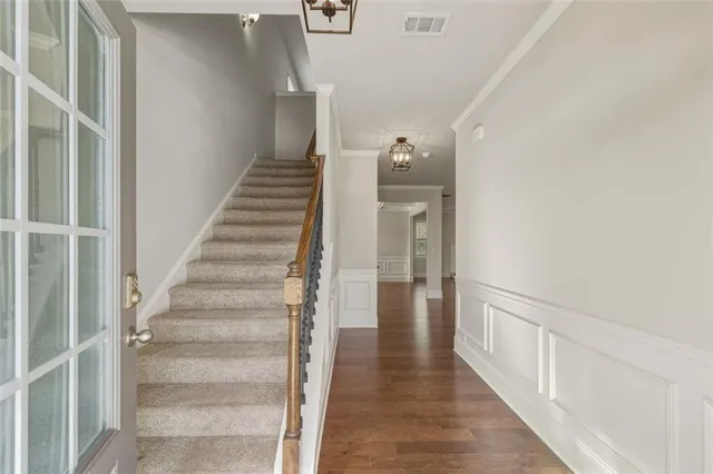 a view of a hallway with wooden floor and entryway