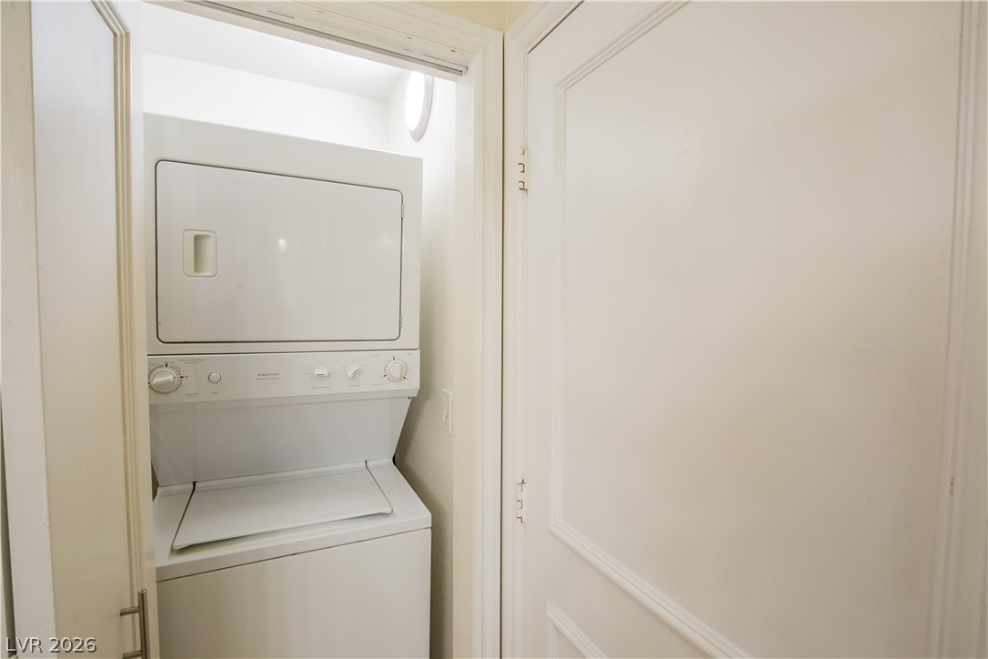 230 East Flamingo Road, Unit 122 Las Vegas, NV 89169 - Photo 7 of 7 A compact laundry closet provides convenient and efficient clothes care with a stacked washer and dryer unit.
