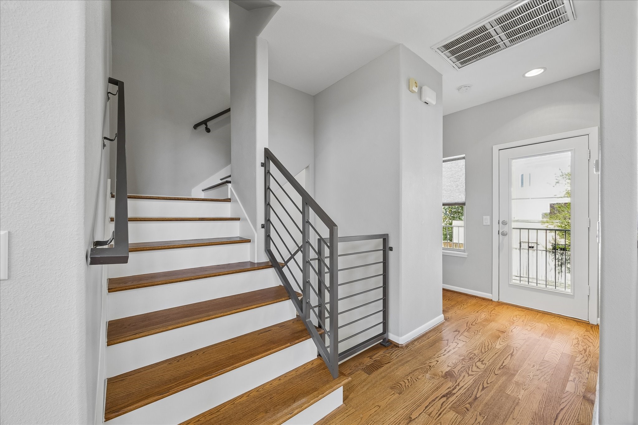 3022 Caroline Street Houston, TX 77004 - Photo 12 of 23 a view of a livingroom with wooden floor and stairs