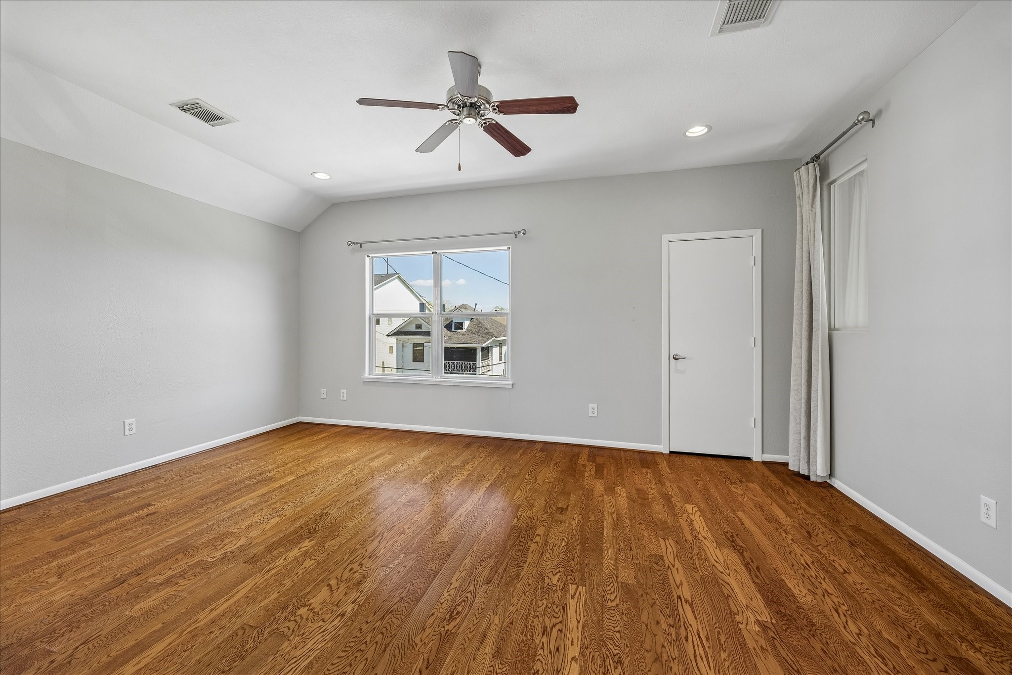 3022 Caroline Street Houston, TX 77004 - Photo 14 of 23 a view of empty room with wooden floor and fan