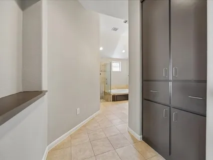 a bathroom with a tub a sink and a mirror