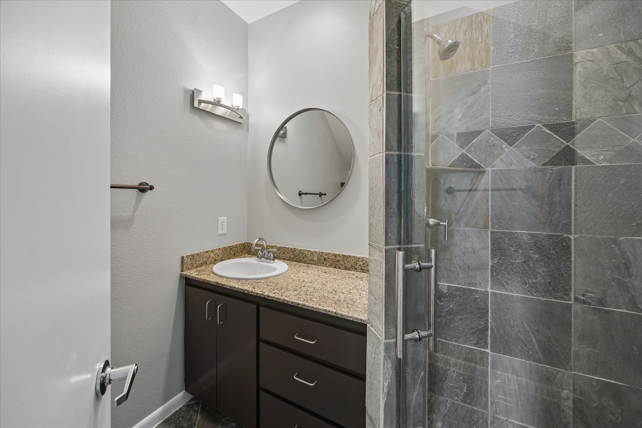 3022 Caroline Street Houston, TX 77004 - Photo 3 of 23 a bathroom with a granite countertop sink a toilet and a mirror
