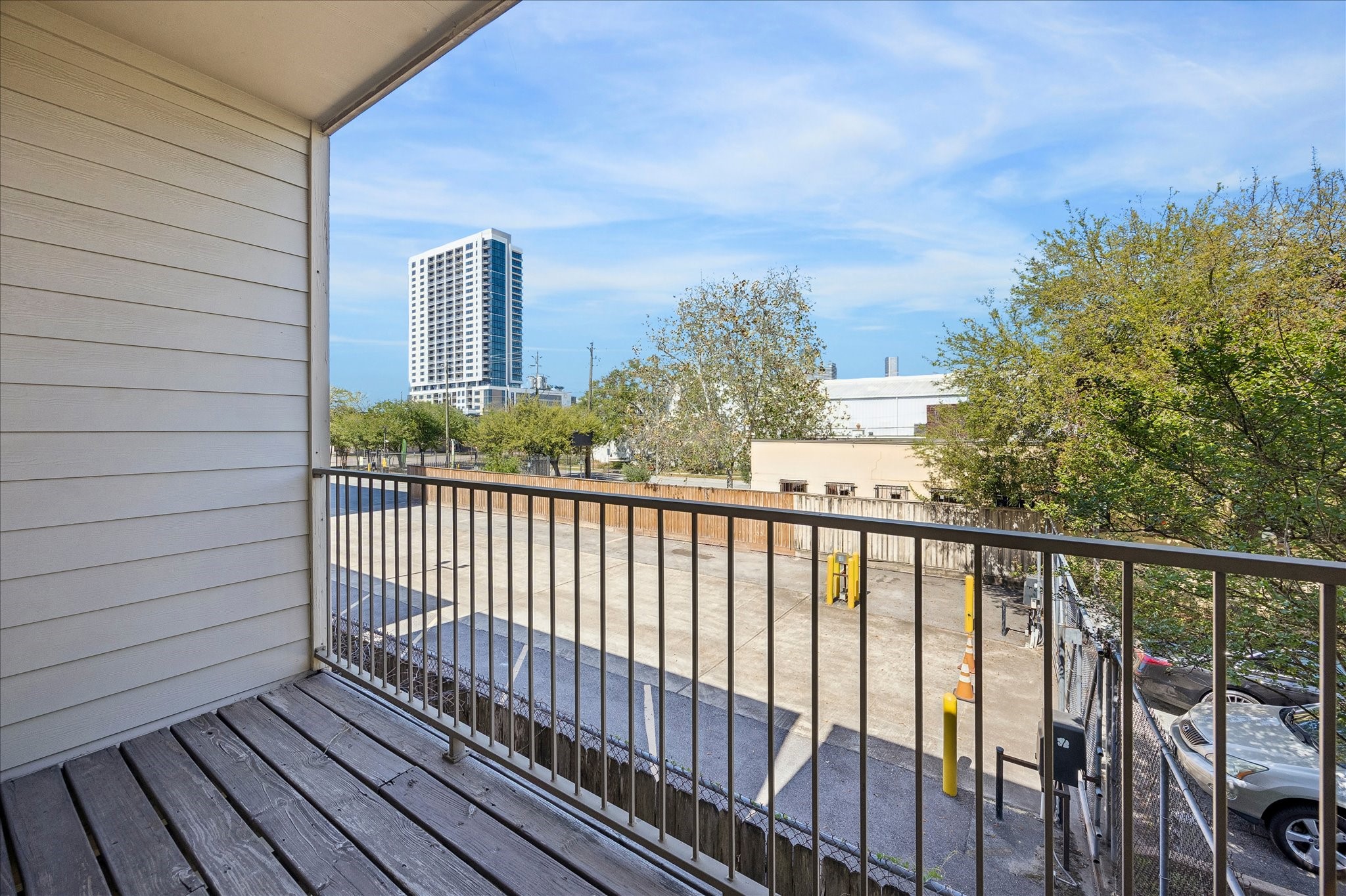 3022 Caroline Street Houston, TX 77004 - Photo 6 of 23 a view of a balcony with wooden fence