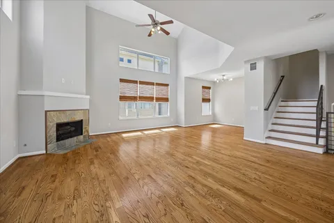 a view of empty room with wooden floor and fireplace