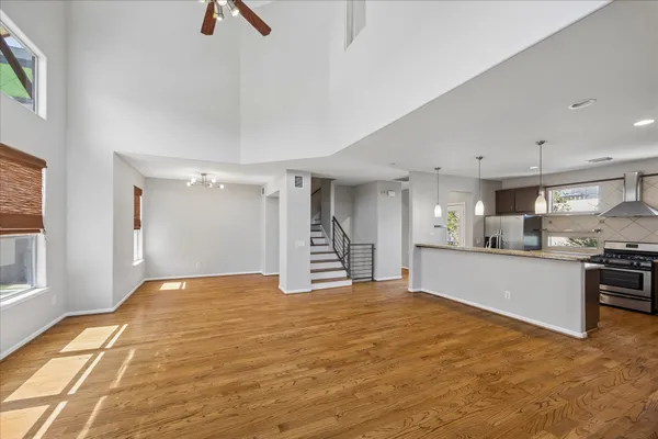 a view of kitchen with kitchen island wooden floor center island and stainless steel appliances