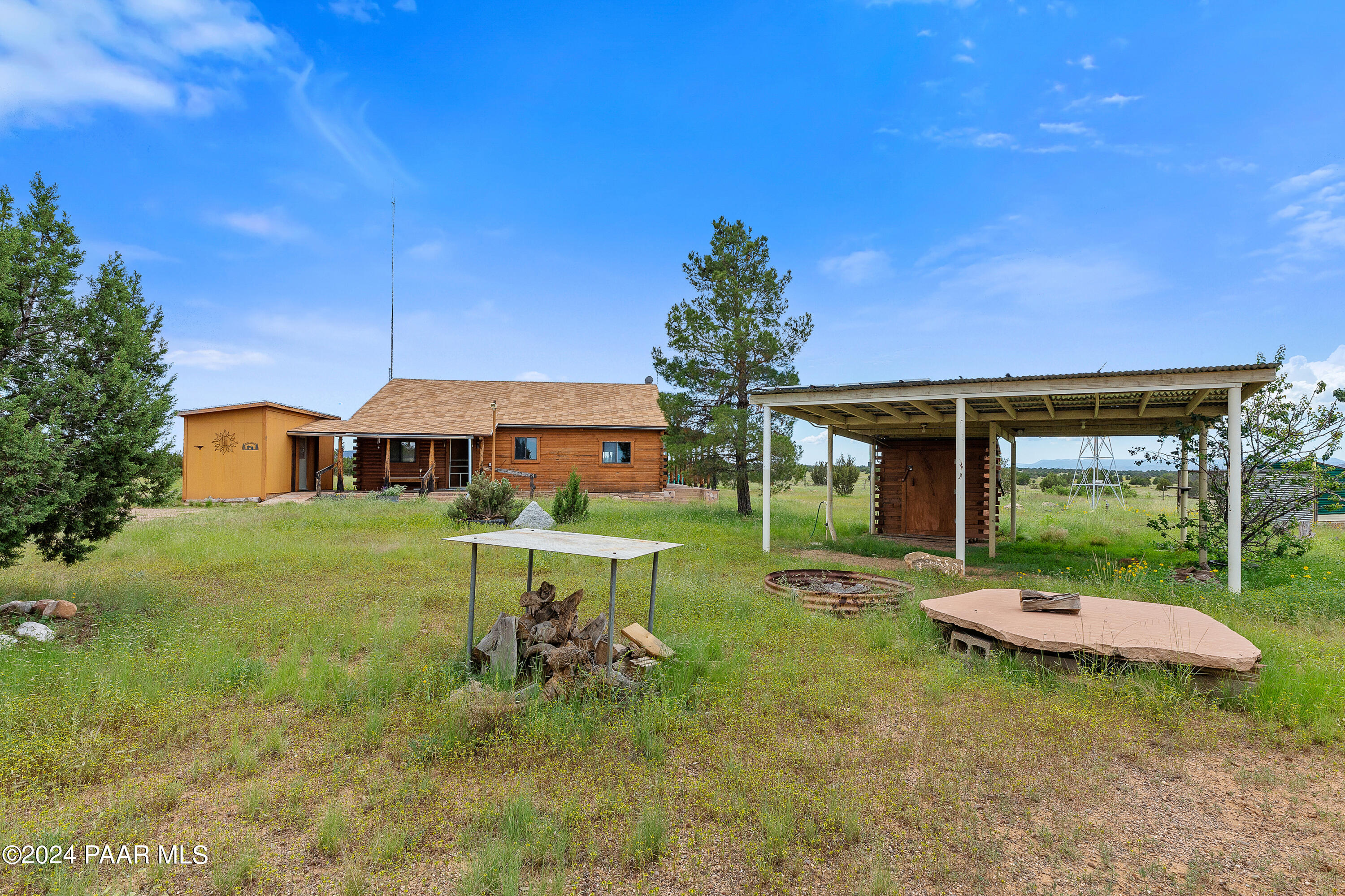 9797 Rocky Rabbit Road Ash Fork, AZ 86320 - Photo 3 of 36 a front view of a house with garden