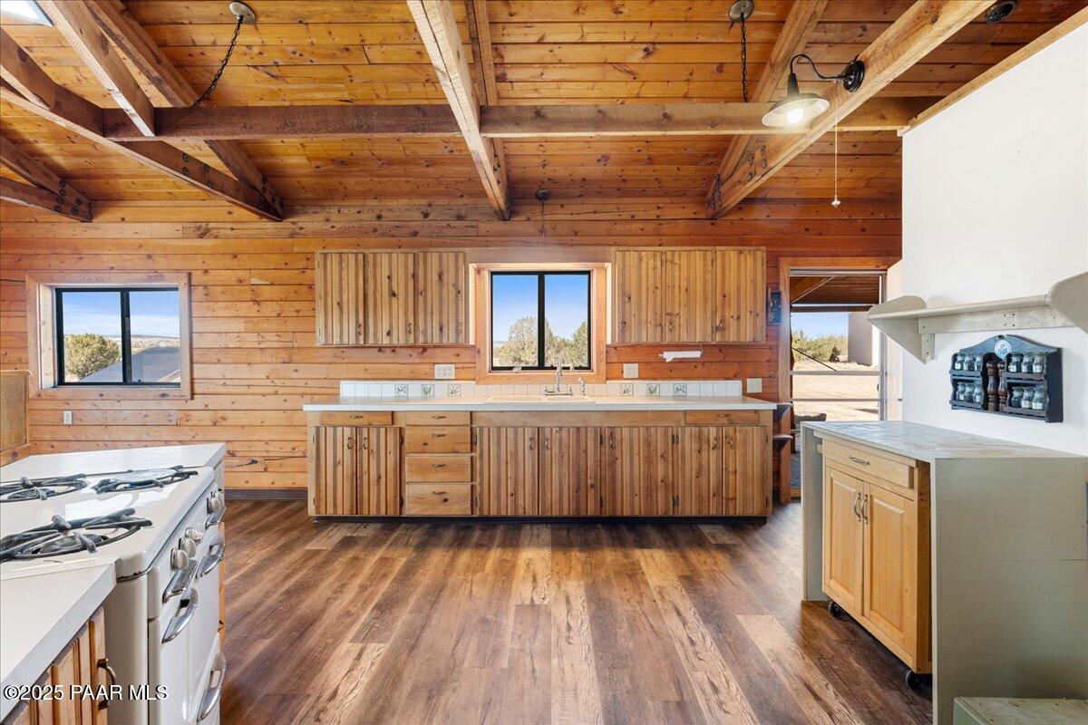 9797 Rocky Rabbit Road Ash Fork, AZ 86320 - Photo 8 of 36 a kitchen with a lot of counter top space and wooden floor