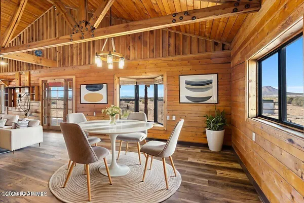 a view of a patio with table and chairs and wooden floor