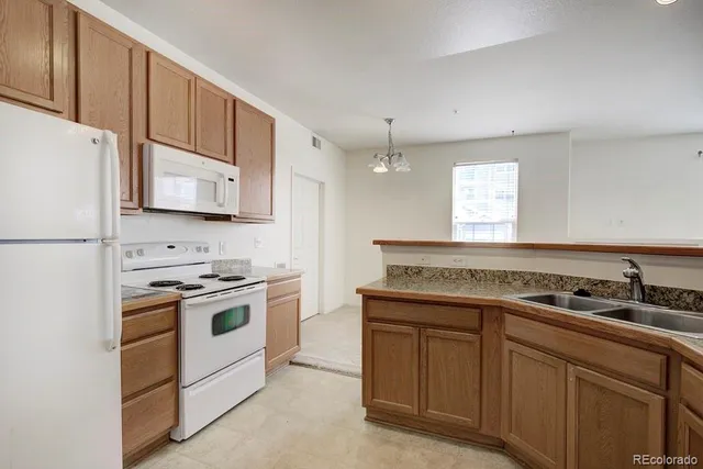 a kitchen with a stove and white cabinets