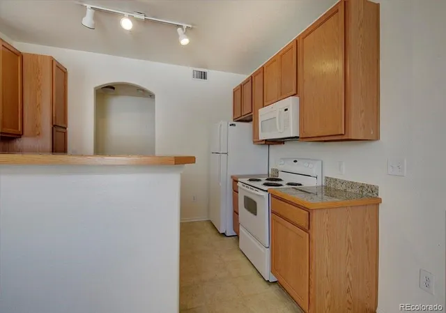a kitchen with stainless steel appliances granite countertop a sink and a stove