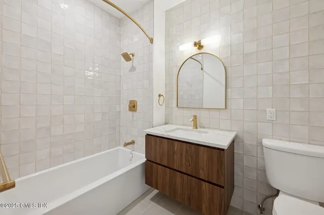 a bathroom with a sink a toilet and a bathtub