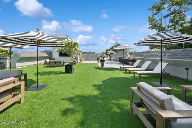 a view of a backyard with sitting area