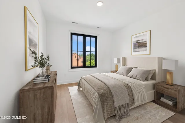 a bedroom with a bed and a potted plant