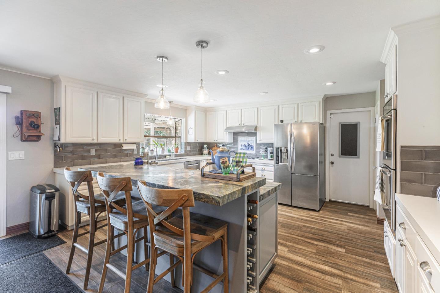 150 Jonquil Lane Hollister, CA 95023 - Photo 20 of 61 a kitchen with stainless steel appliances a dining table chairs refrigerator and sink
