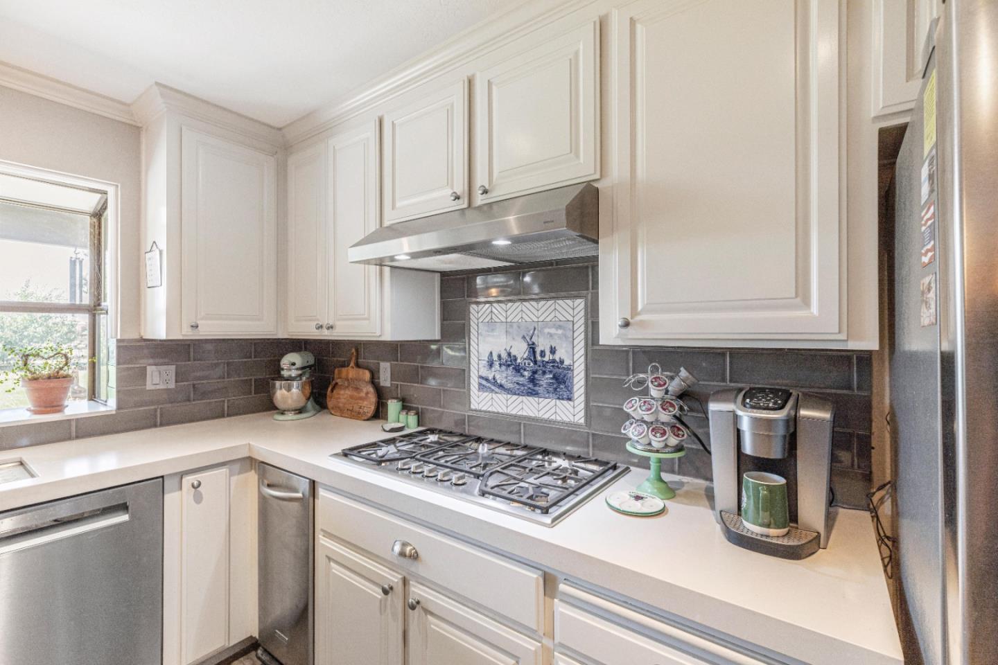 150 Jonquil Lane Hollister, CA 95023 - Photo 25 of 61 a kitchen with an oven a cabinets and a window