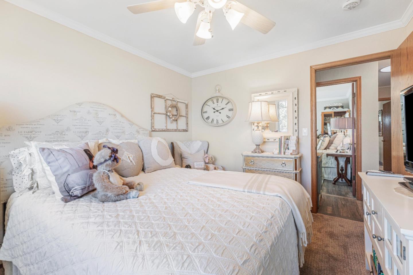 150 Jonquil Lane Hollister, CA 95023 - Photo 36 of 61 a bedroom with a large bed and a chandelier