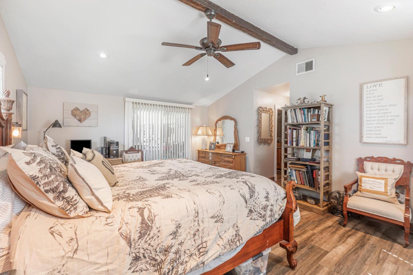 150 Jonquil Lane Hollister, CA 95023 - Photo 43 of 61 a spacious bedroom with a bed a table and a book shelf