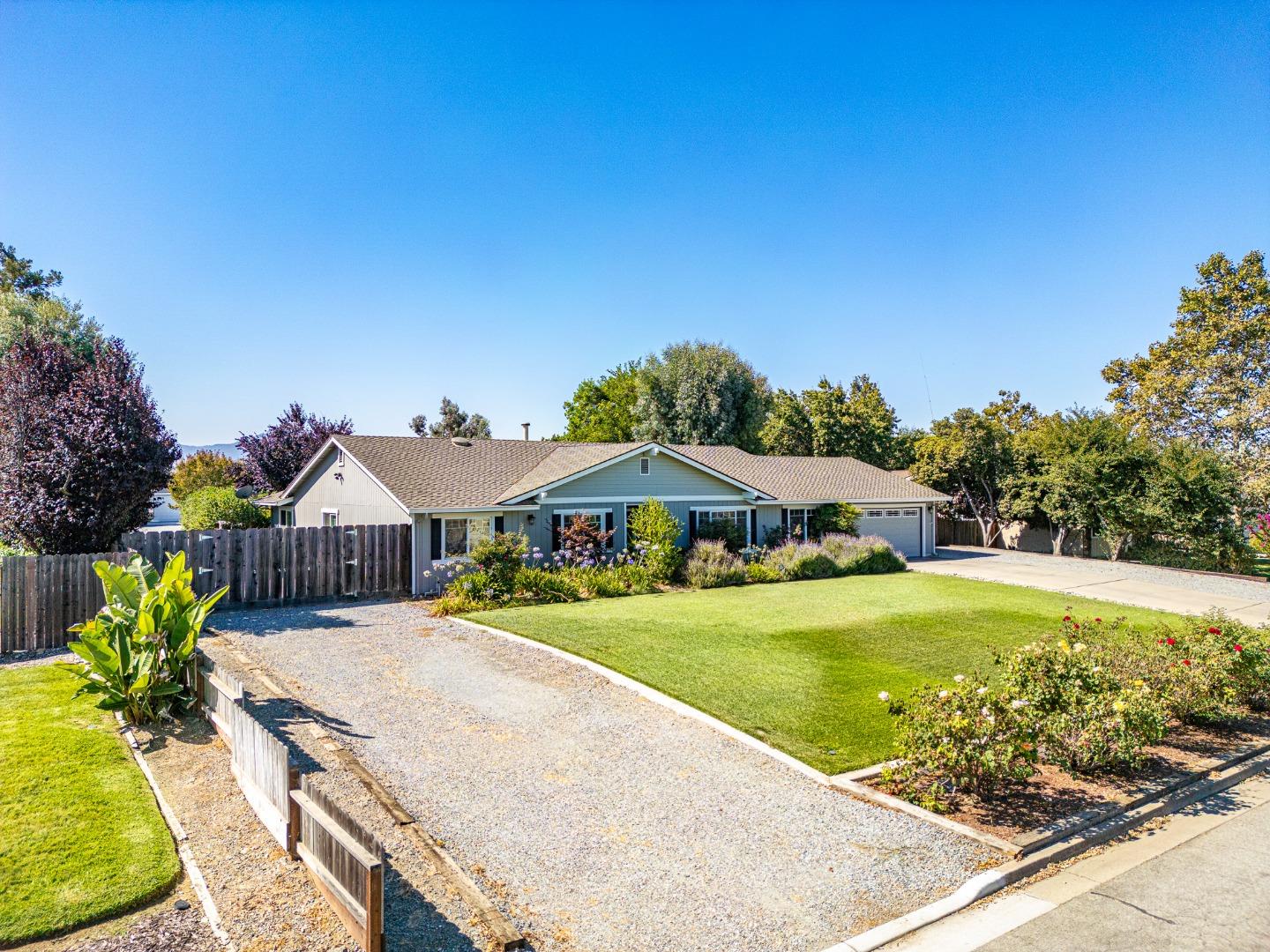 150 Jonquil Lane Hollister, CA 95023 - Photo 60 of 61 a view of a house with a yard and potted plants