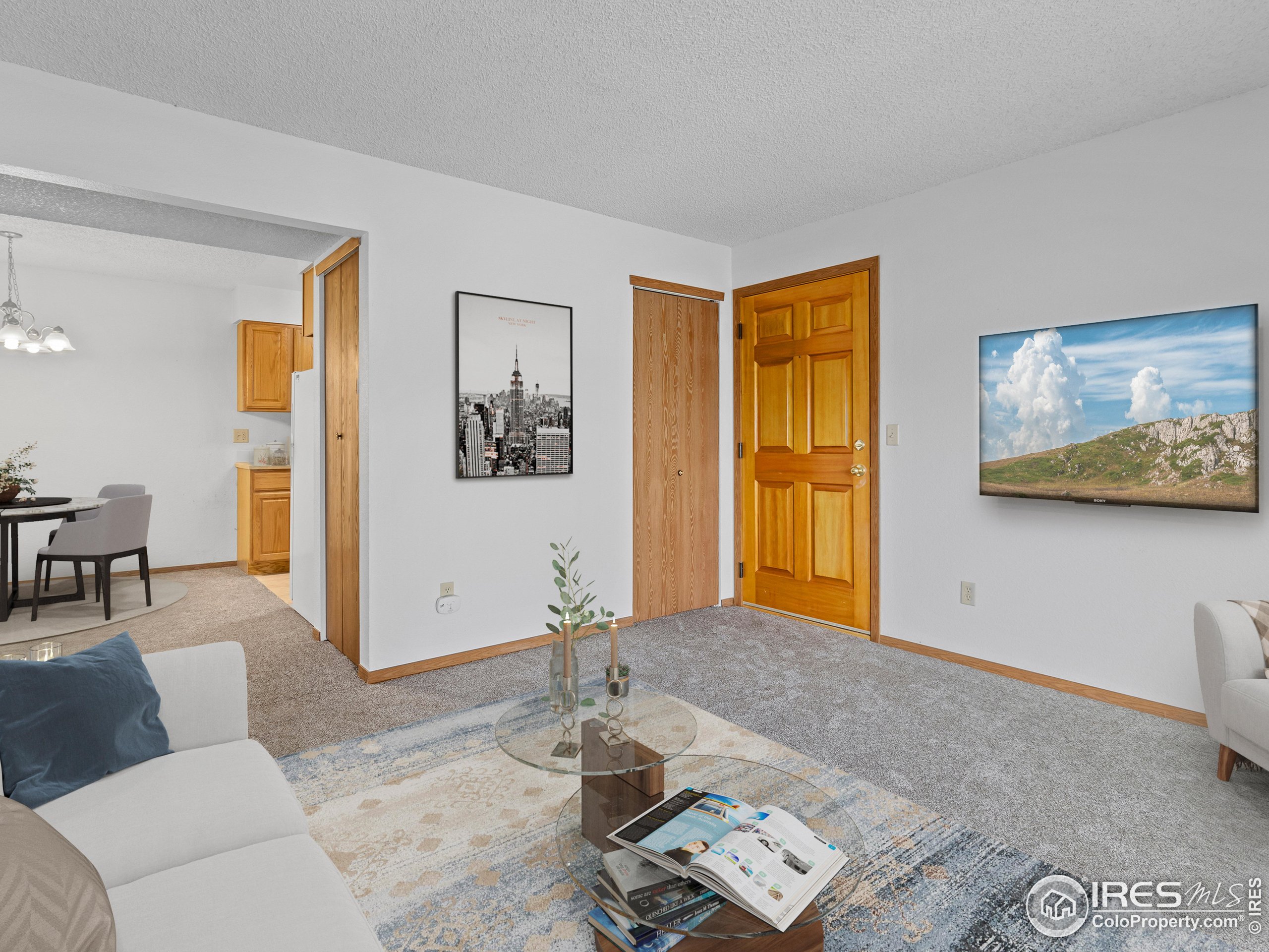 1155 South St Vrain Avenue, Unit 13 Estes Park, CO 80517 - Photo 3 of 18 a living room with furniture and wooden floor
