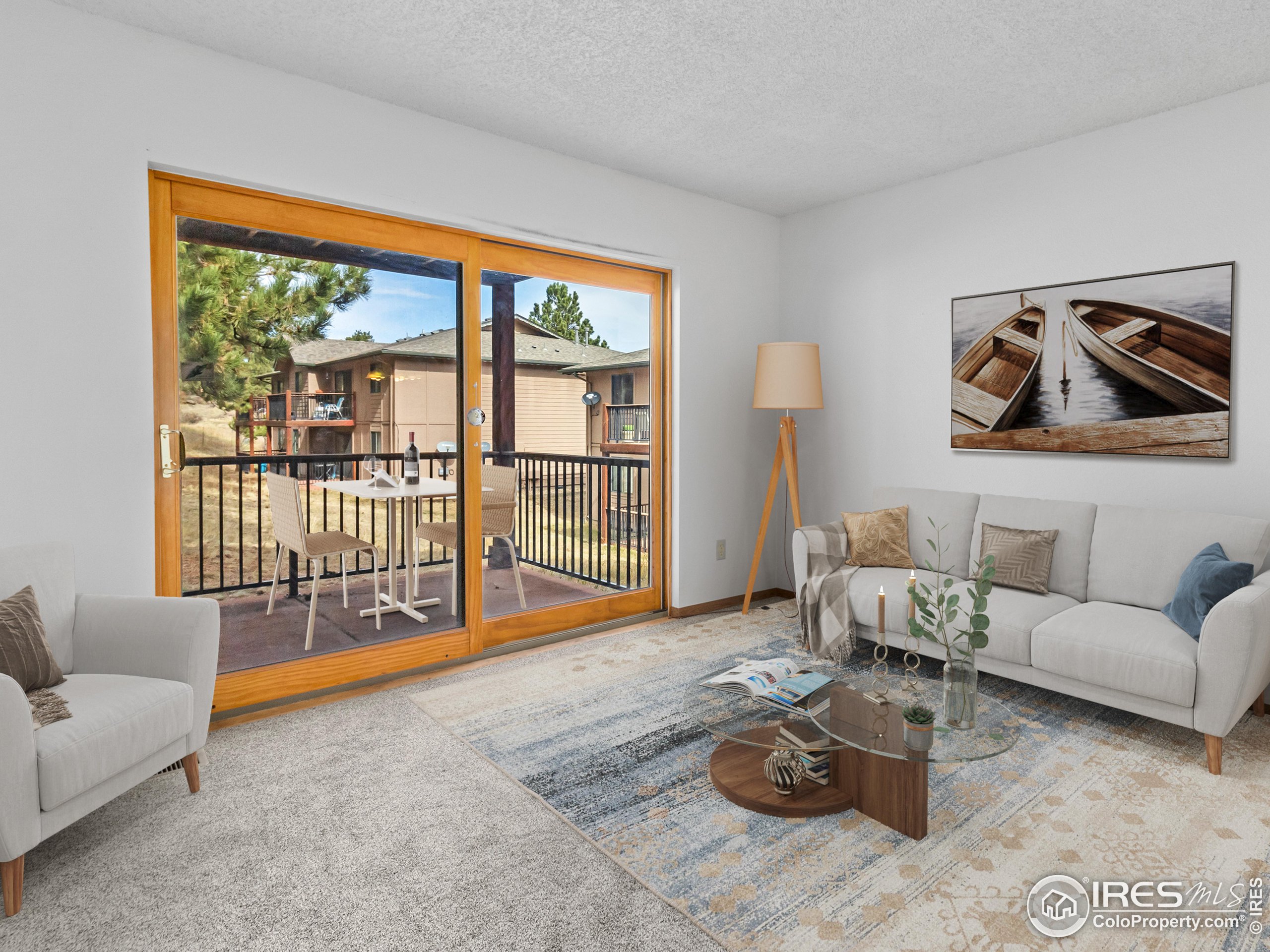1155 South St Vrain Avenue, Unit 13 Estes Park, CO 80517 - Photo 5 of 18 a living room with furniture and a gate