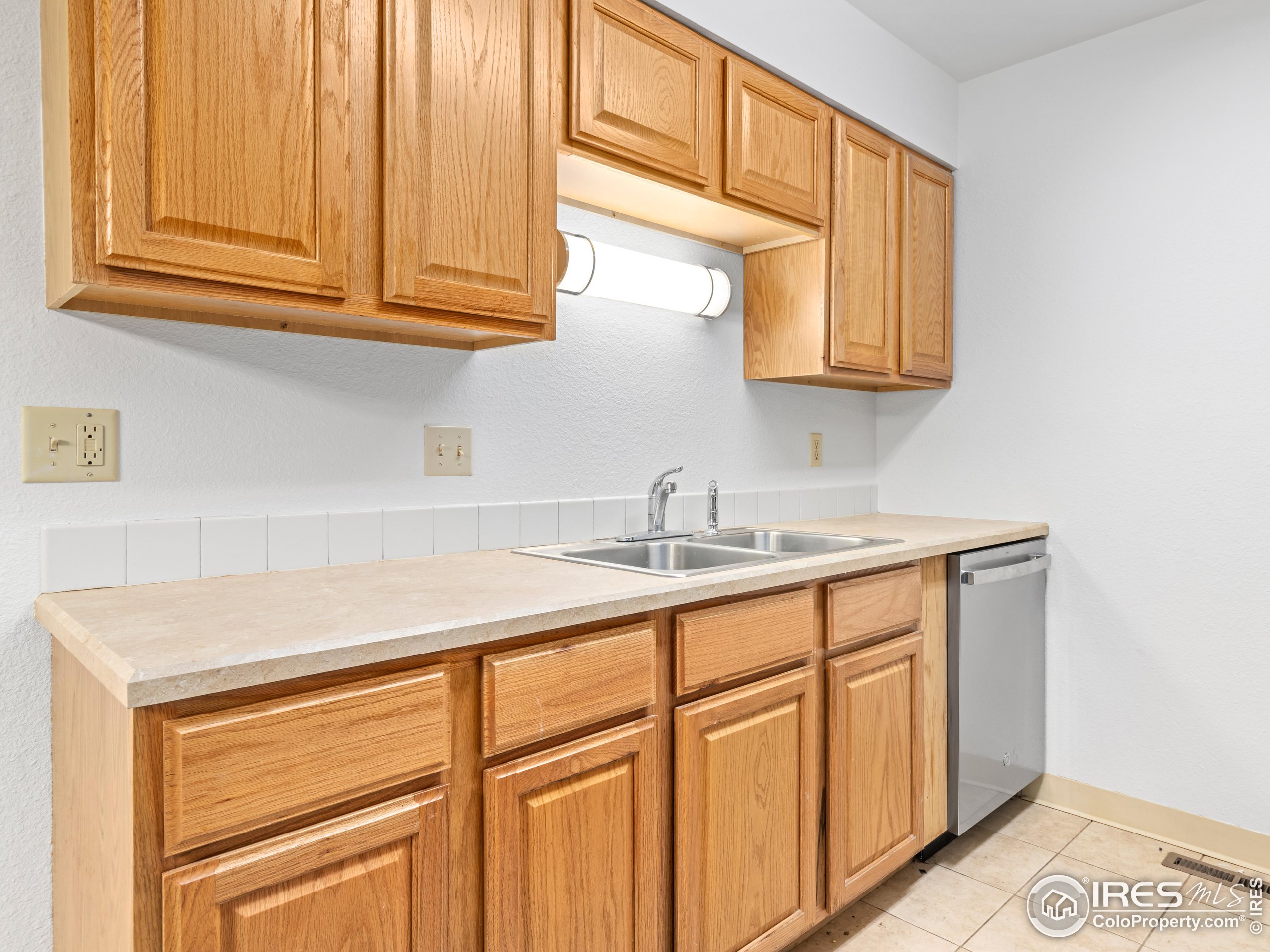 1155 South St Vrain Avenue, Unit 13 Estes Park, CO 80517 - Photo 8 of 18 a kitchen with stainless steel appliances granite countertop a sink and dishwasher with cabinets